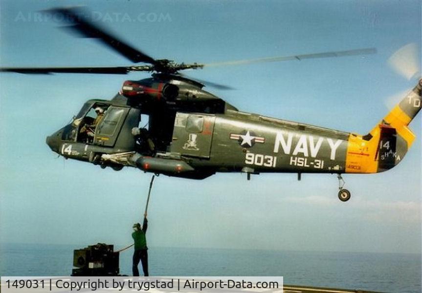 149031, Kaman HH-2D Seasprite C/N 035, Shaka 14 hooks up a cargo load from the deck of USNS Harkness (T-AGS 32)  in the Banda Sea, Indonesia, late 1986. Photo by AE2 Barry Sinclair.