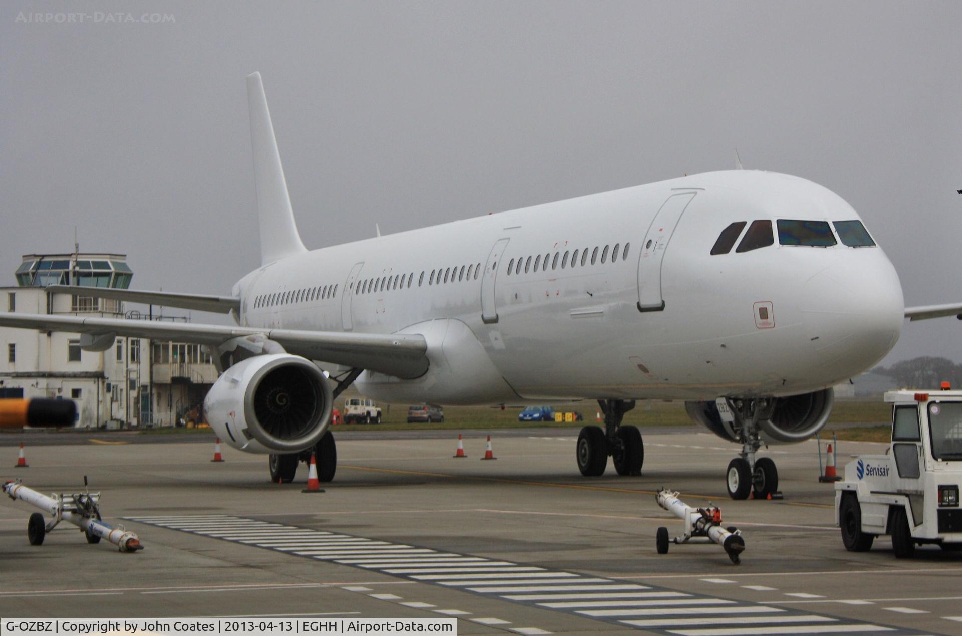G-OZBZ, 2001 Airbus A321-231 C/N 1421, ex TC-OAN temporarily parked on main apron awaiting transfer to Airbourne Colours for respray into Monarch livery
