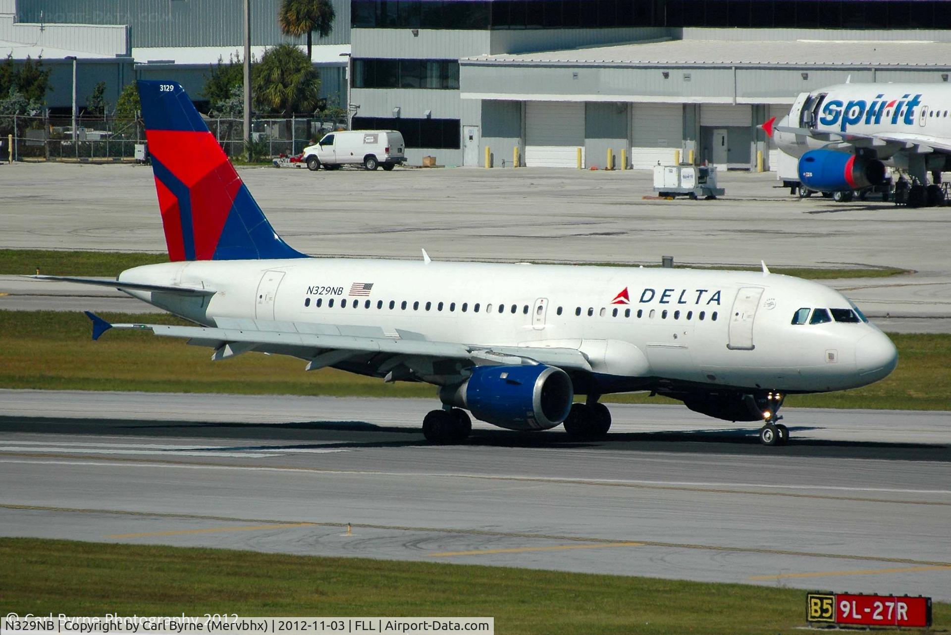 N329NB, 2001 Airbus A319-114 C/N 1543, Taken from the Hibiscus car park viewing area.