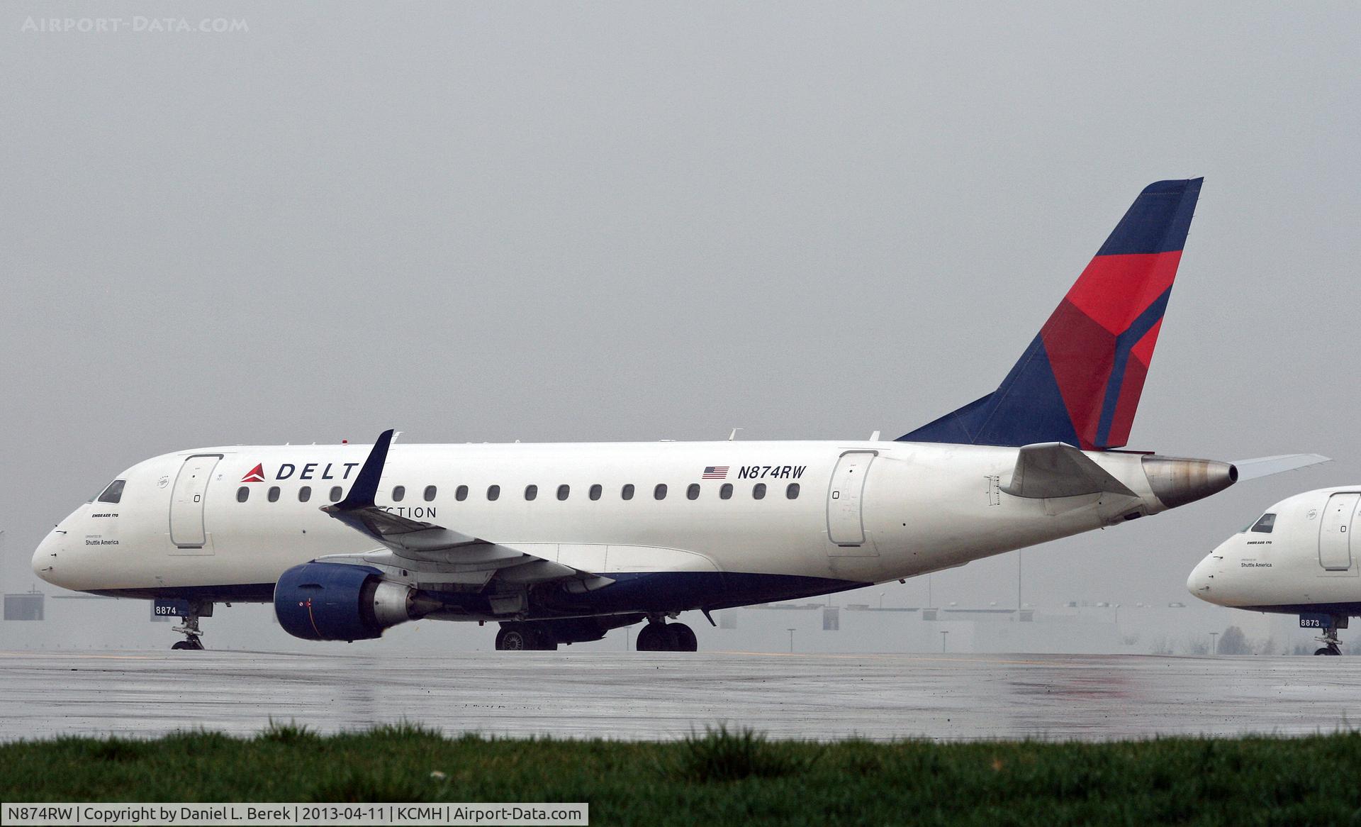 N874RW, 2006 Embraer 170SU (ERJ-170-100SU) C/N 17000148, A Delta Connection ERJ sits it out at a remote corner on a very wet day in Columbus.