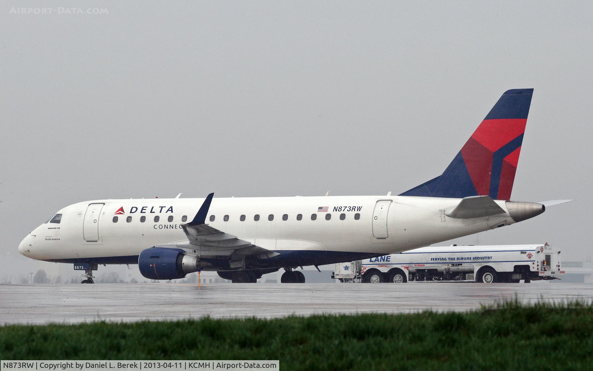 N873RW, 2006 Embraer 170SU (ERJ-170-100SU) C/N 17000144, Formerly in Midwest colors, this regional jet now serves Delta Connection.  She sits out a rain storm on a remote stand at Port Columbus International.