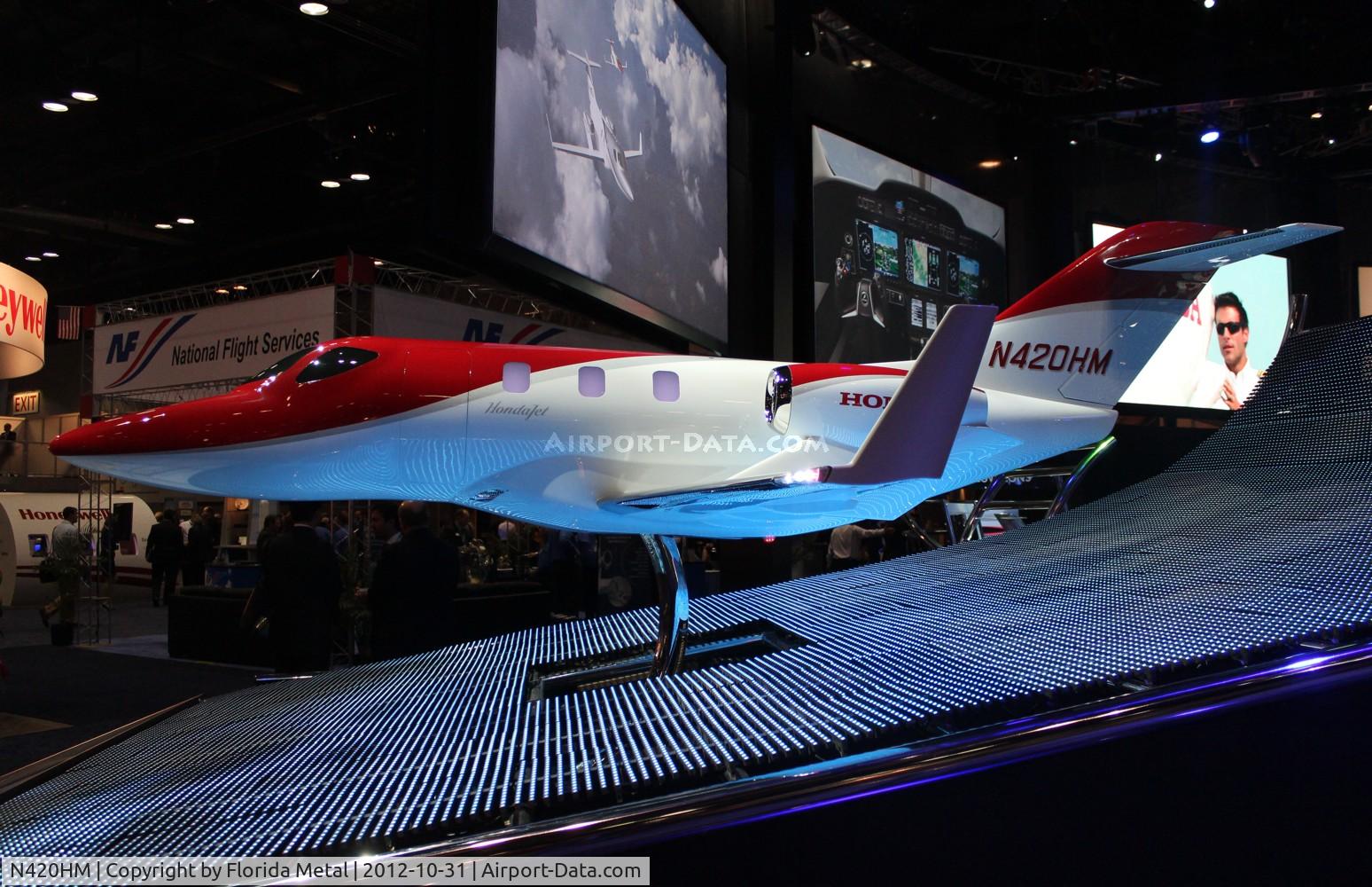 N420HM, 2011 Honda HA-420 HondaJet C/N 42000002, Large scale model with working lights of Honda Jet at Orange County Convention Center Orlando for NBAA