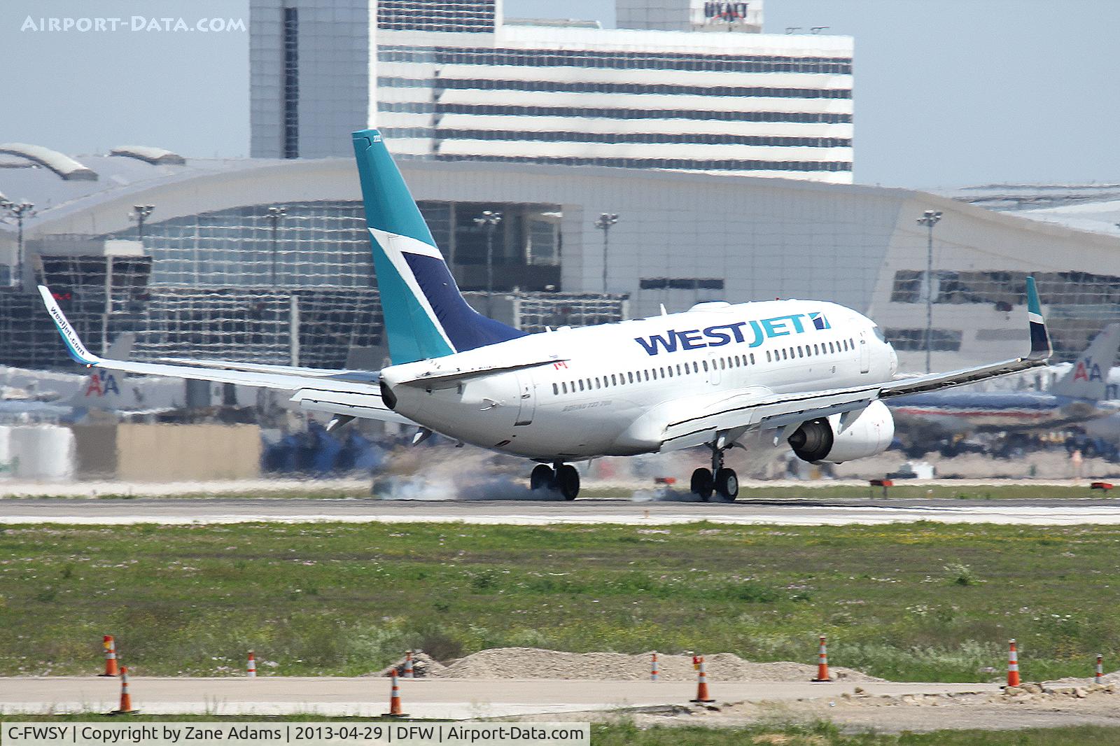 C-FWSY, 2004 Boeing 737-7CT C/N 32762, WestJet's first flight landing at DFW Airport