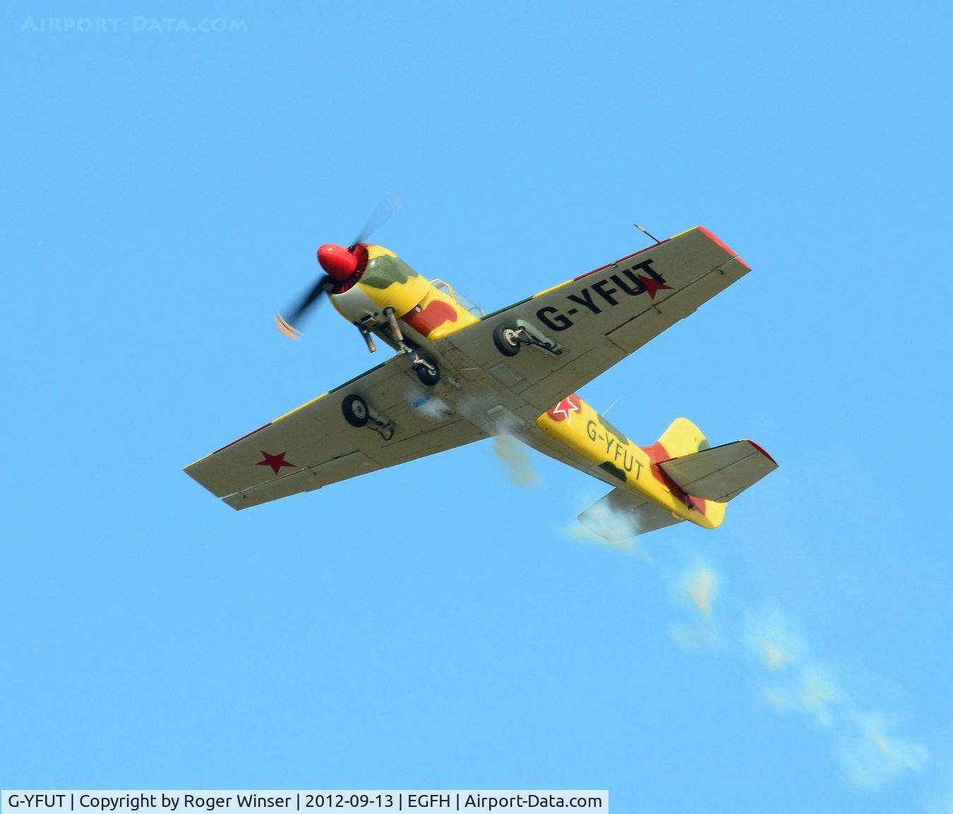 G-YFUT, 1988 Bacau Yak-52 C/N 888410, Yak-52 putting on smoke.