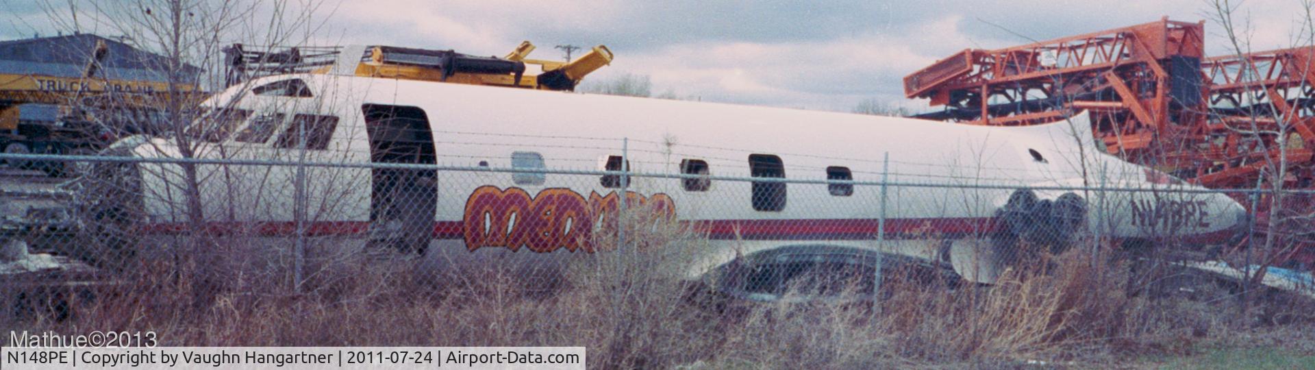 N148PE, 1961 Lockheed L-1329 JetStar 6 C/N 5002, N148PE sits heavily stripped in the early spring overcast, inside the yard of a crane operator in Golden Valley, MN. Early to mid 1990's. Due to a huge mud puddle I could not take the shot any closer.