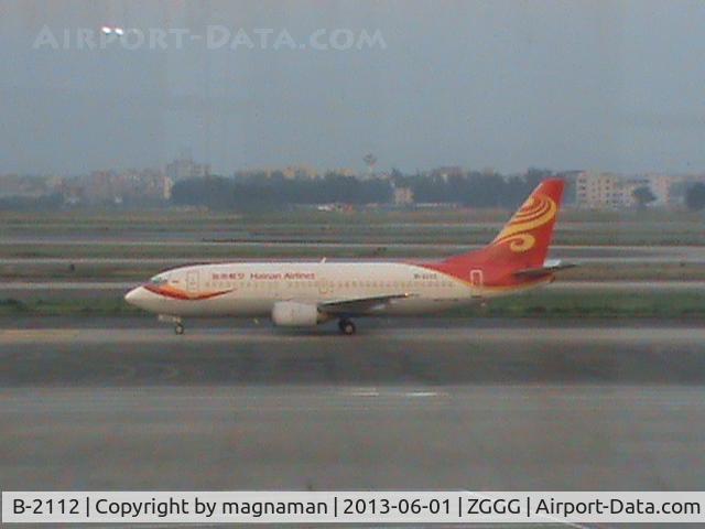 B-2112, 1999 Boeing 737-36N C/N 28599, Taxying by international terminal - shot through dirty glass windows