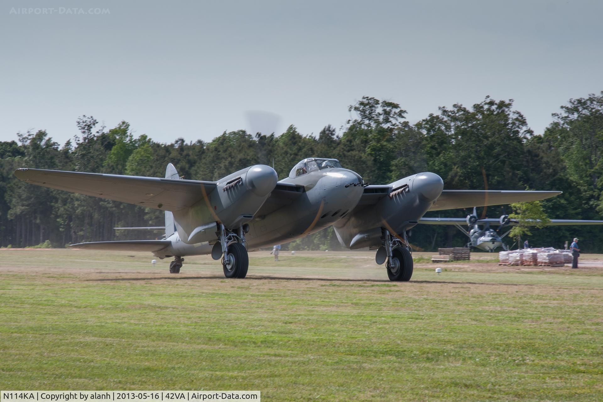 N114KA, 1945 De Havilland Mosquito FB.26 C/N KA114, Taxying prior to departure for an air to air photo sortie. The polythene covered pallets in the background are bricks from a British WWII airfield control tower, due to be rebuilt at the Military Aviation Museum site.