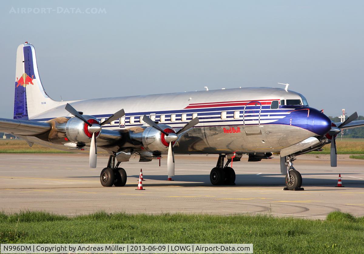 N996DM, 1958 Douglas DC-6B C/N 45563, Red Bull DC-6 in the morning sun.