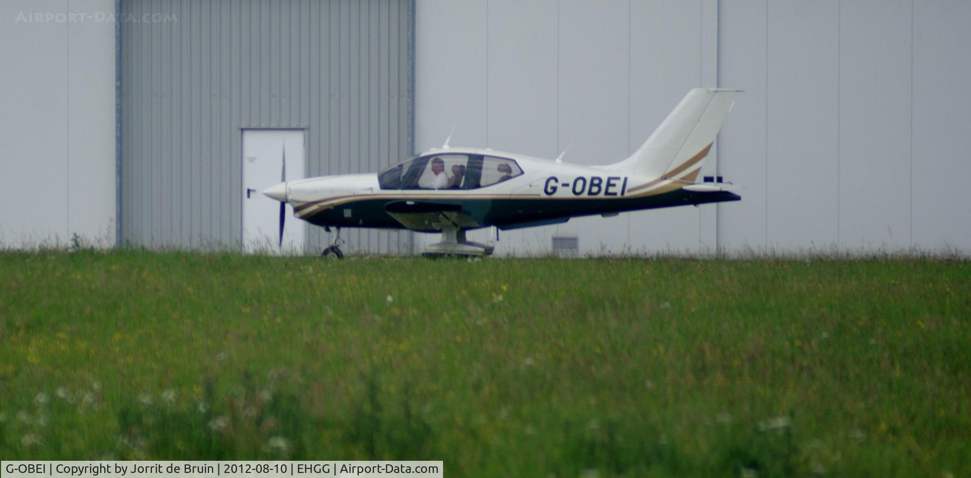 G-OBEI, 2002 Socata TB-200 Tobago XL C/N 2096, The pilot in command of the G-OBEI is just checking his charts in front of the flight club, as he is about to start the engines for another local IFR flight.