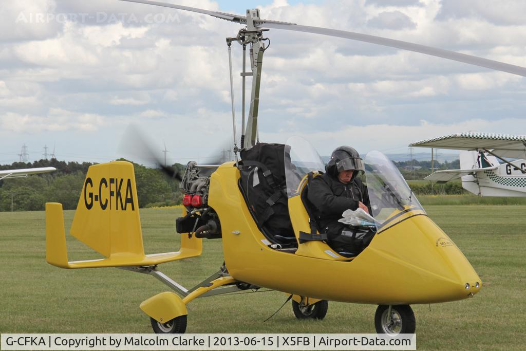 G-CFKA, 2008 Rotorsport UK MT-03 C/N RSUK/MT-03/051, Rotorsport UK MT-03. A Fly UK 2013 team member plans the next leg of the journey to Eshott!. Fishburn Airfield, June 2013.