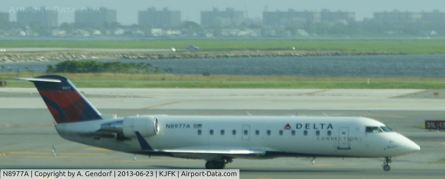 N8977A, 2004 Canadair CRJ-440 (CL-600-2B19) Regional Jet C/N 7977, Pinnacle Air (Delta Connection cs.), is here on taxiway at New York - JFK(KJFK)