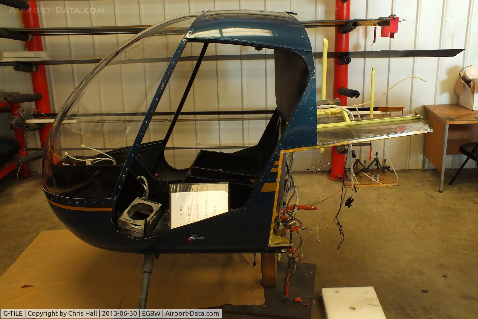 G-TILE, 1989 Robinson R22 Beta C/N 1100, pod of R22 G-TILE inside the Heliair hangar