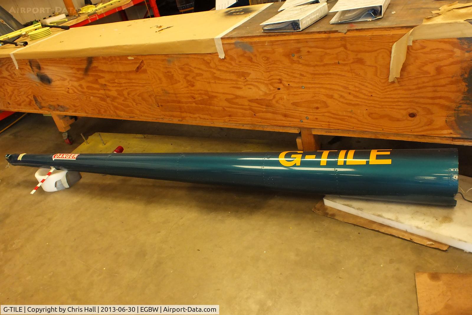 G-TILE, 1989 Robinson R22 Beta C/N 1100, boom of R22 G-TILE inside the Heliair hangar