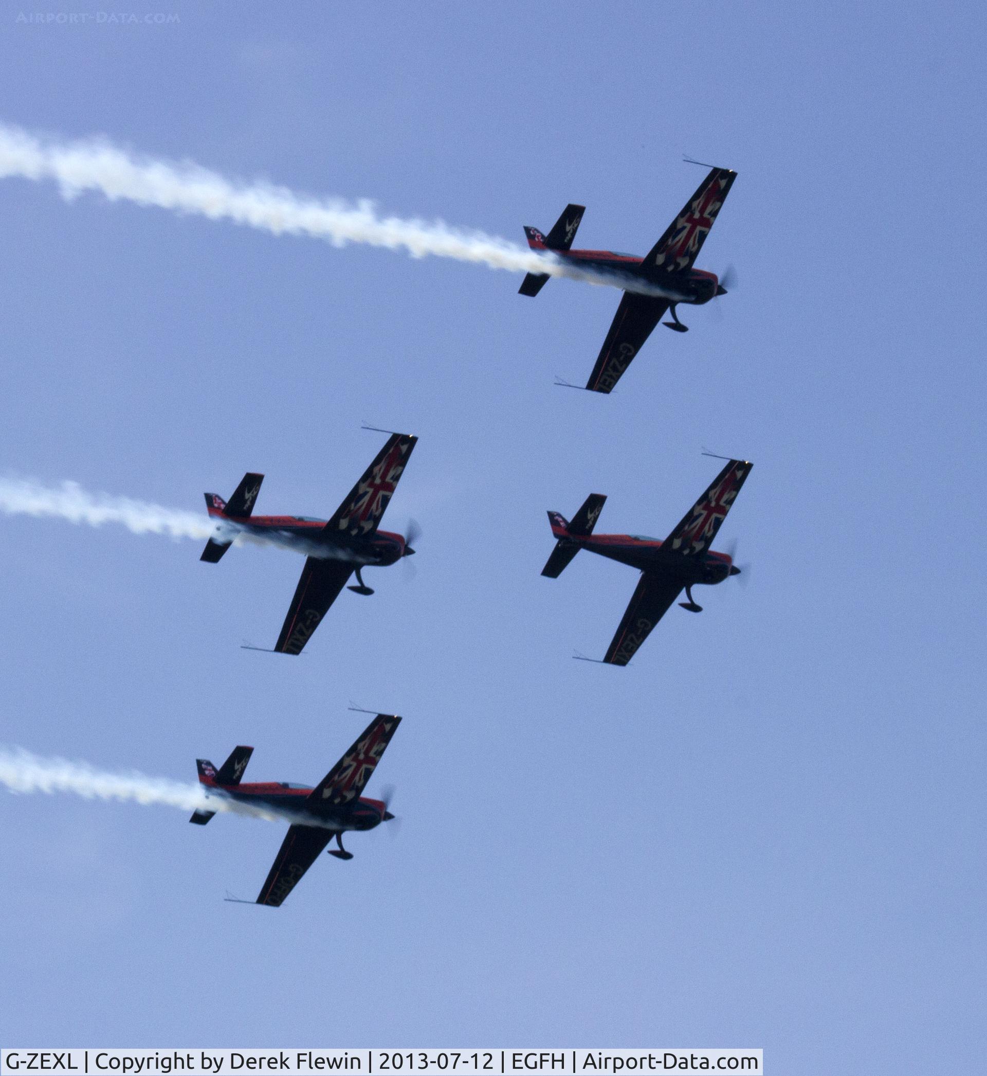 G-ZEXL, 2006 Extra EA-300L C/N 1225, The Blades Display Team, also in the formation, G-ZXEL, G-OFFO and G-ZXLL, fly past down runway 04 at EGFH en-route to RNAS Yeolviton for the display weekend.