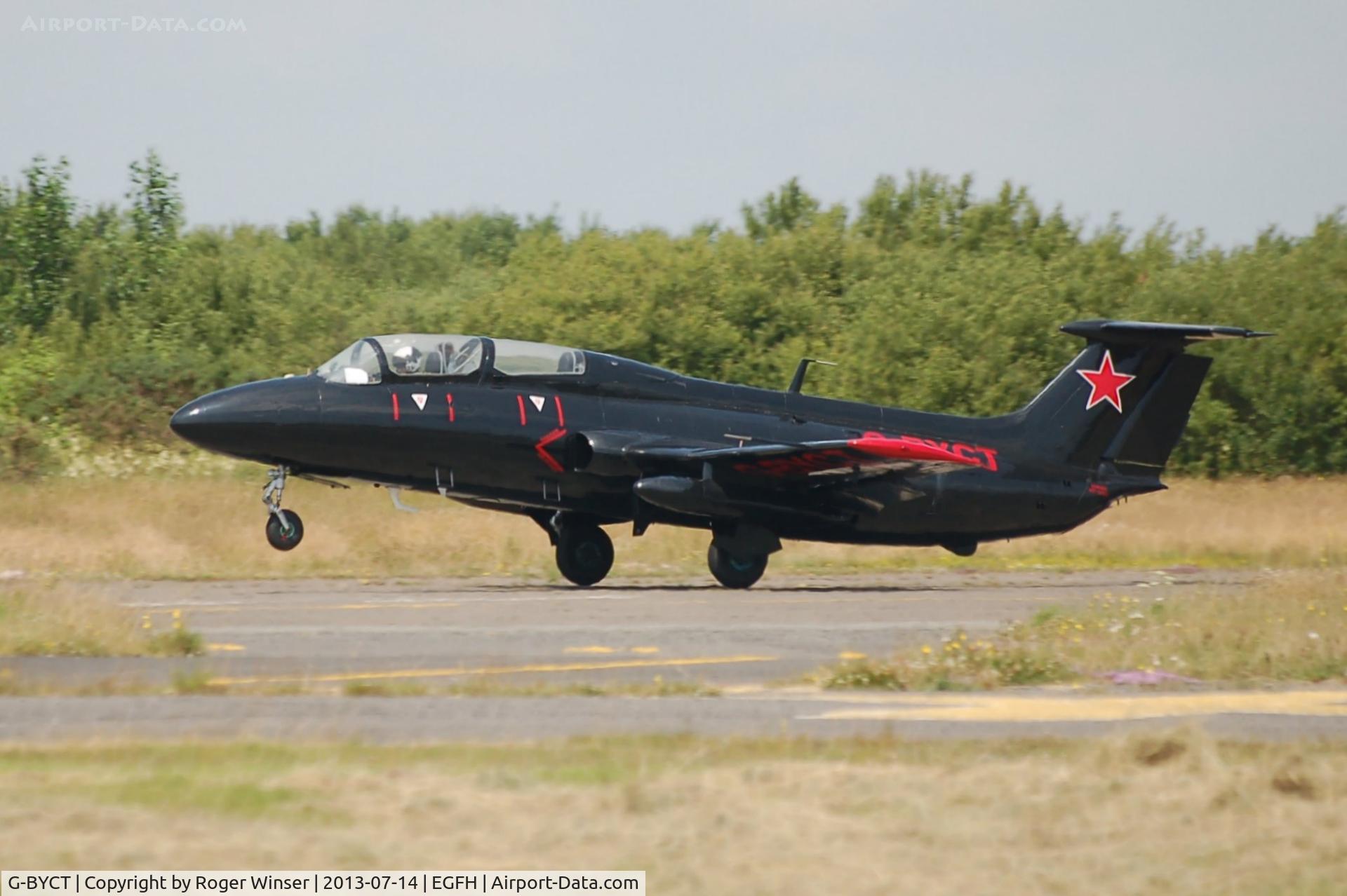 G-BYCT, 1973 Aero L-29 Delfin C/N 395142, Rebel 2 of the Red Star Rebel formation aerobatics team departing to display on the second day of the Wales National Air Show, Swansea Bay.
