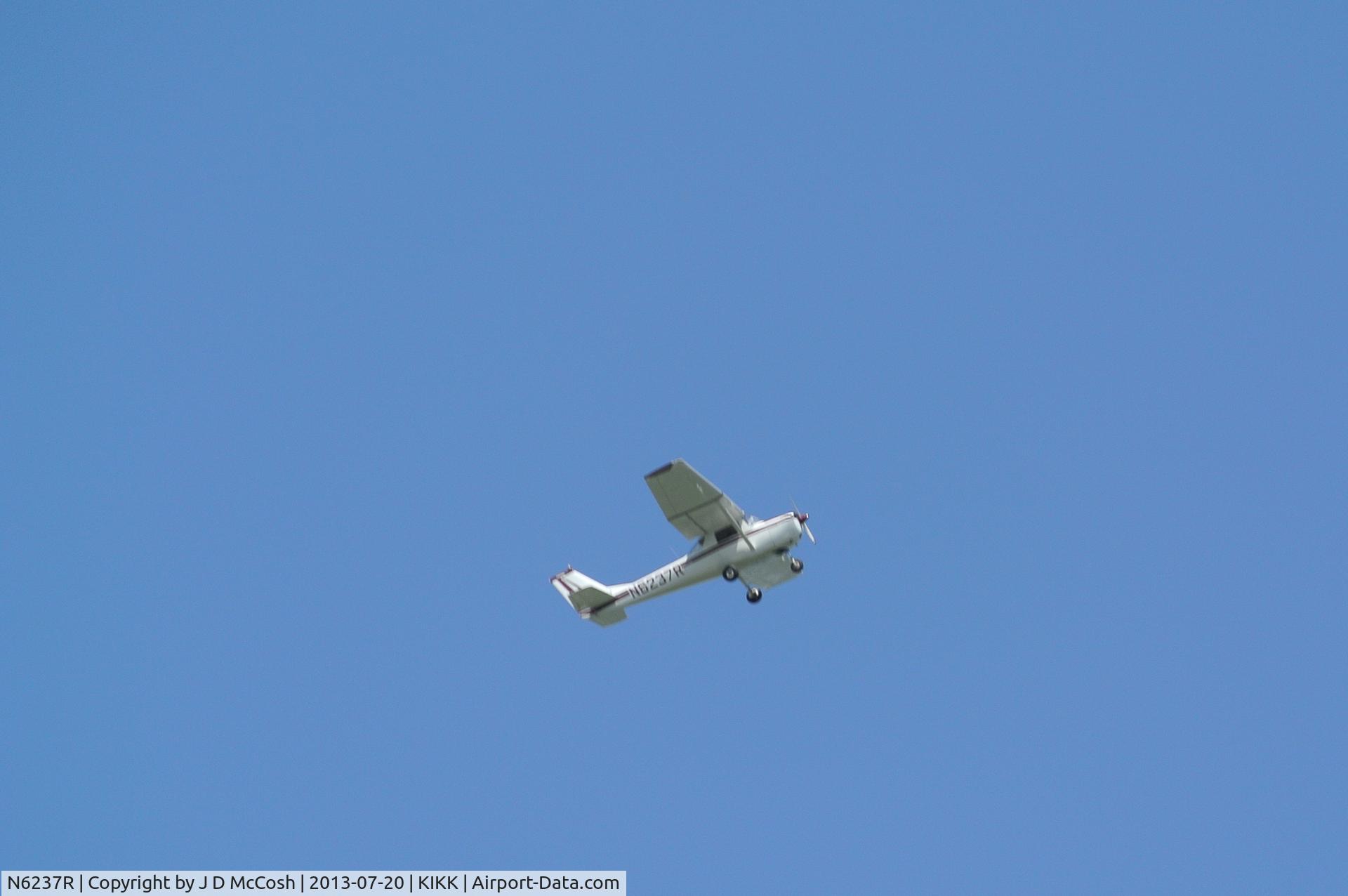 N6237R, 1965 Cessna 150F C/N 15061537, N6237R climbing out of KIKK on July 19, 2013. Taken from moving boat in the Kankakee River.