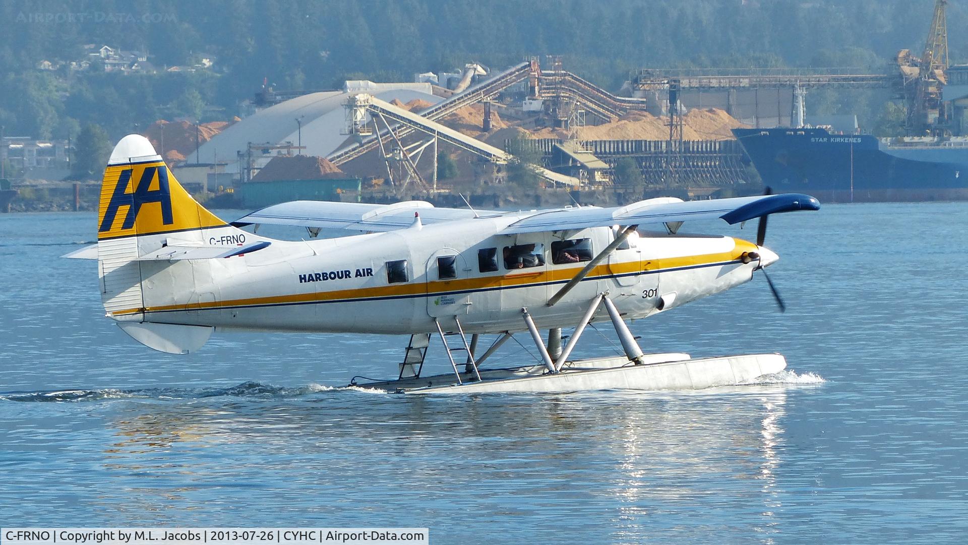 C-FRNO, 1953 De Havilland Canada DHC-3 Turbo Otter C/N 21, Harbour Air #301 taxiing to takeoff position in Coal Harbour.  Fibreco wood chip terminal in background in North Vancouver.
