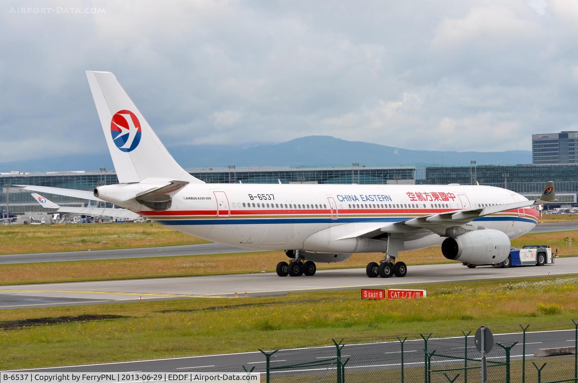 B-6537, 2011 Airbus A330-243 C/N 1262, China Eastern A332 towed to terminal.
