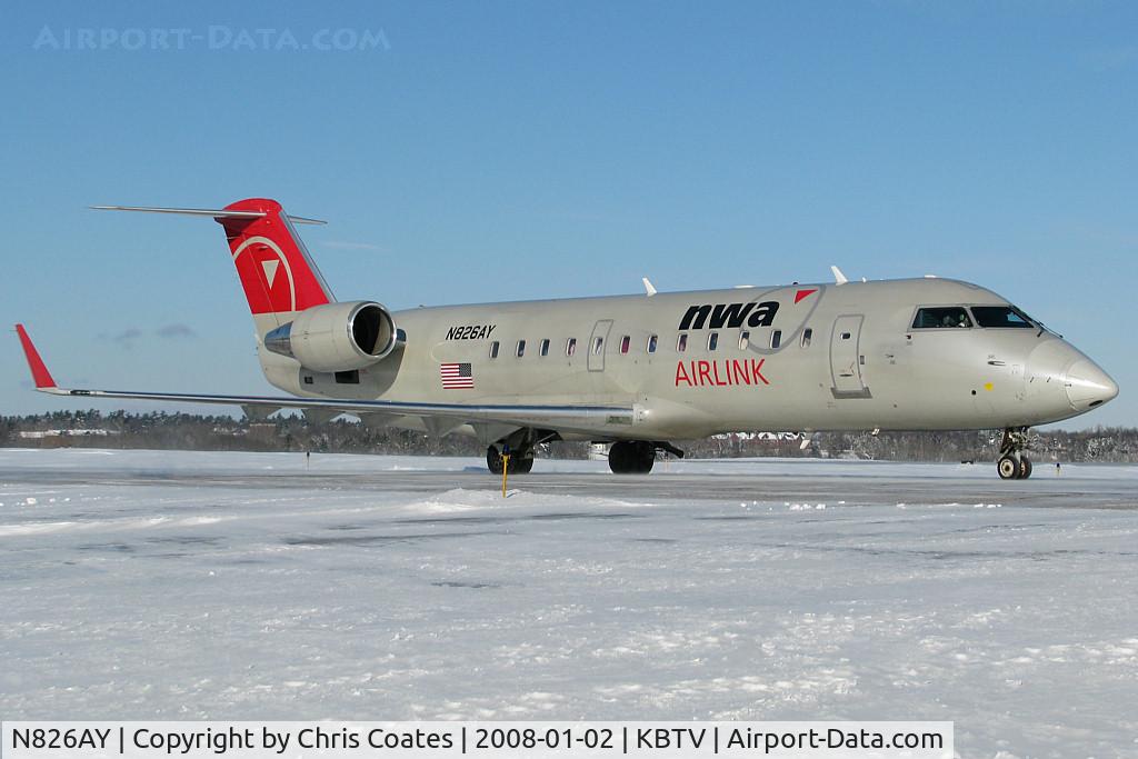 N826AY, 2005 Bombardier CRJ-200ER (CL-600-2B19) C/N 8026, This CRJ just landed & was taxiing to the terminal gates as F-16's from the 158th Fighter Wing of the Vermont ANG were taking off in the background.