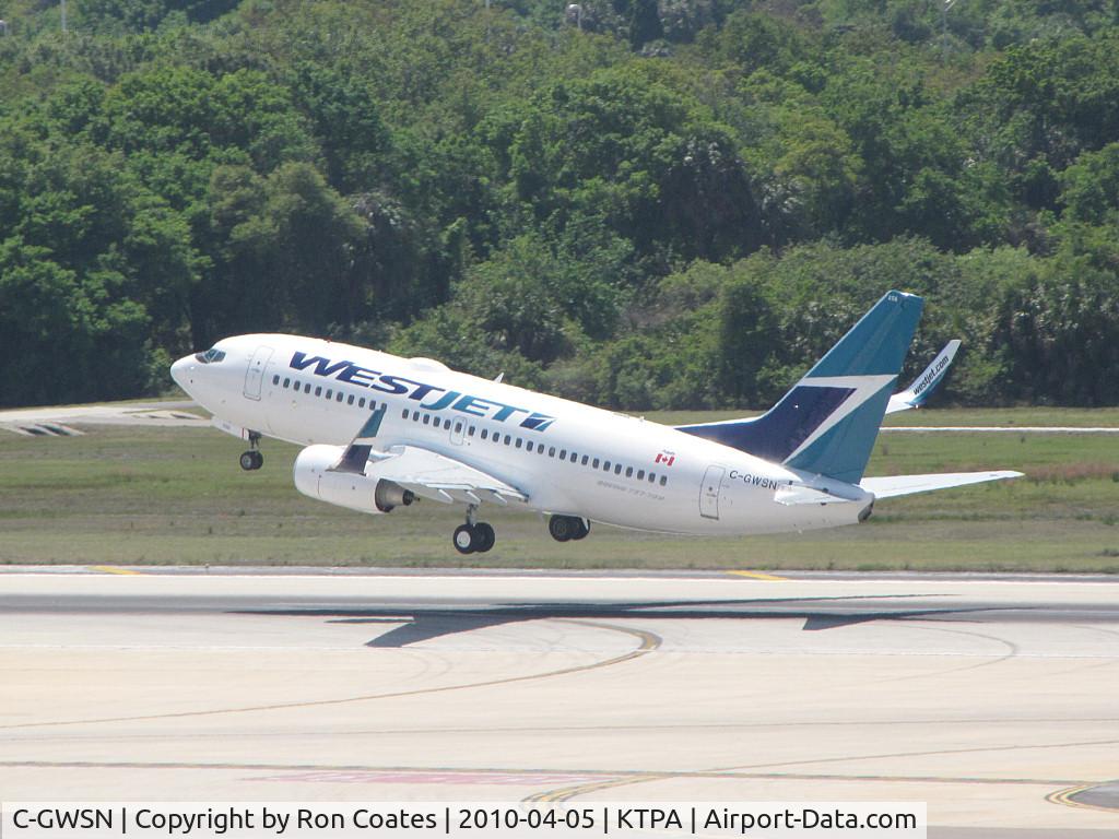 C-GWSN, 2009 Boeing 737-7CT C/N 37089, Lifting off runway 18R at Tampa Int'l Airlines this Boeing 737 of Westjet Airlines heads out over Tampa Bay