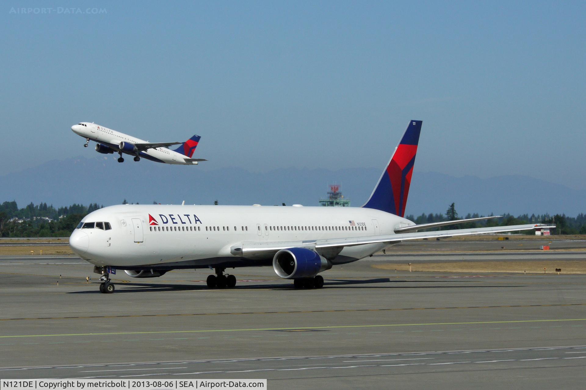 N121DE, 1987 Boeing 767-332 C/N 23435, with little brother at SeaTac
