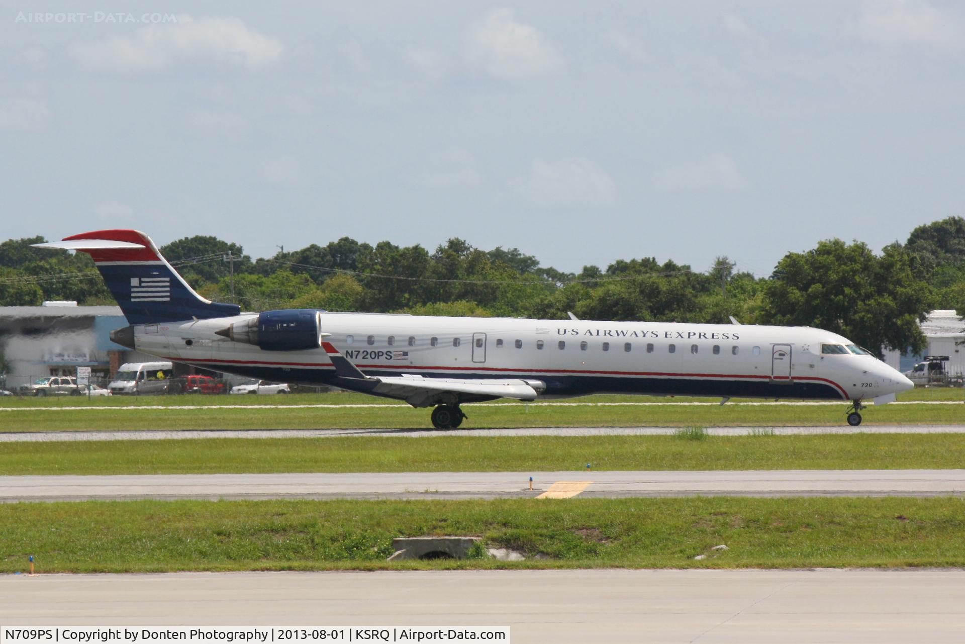 N709PS, 2004 Bombardier CRJ-701 (CL-600-2C10) Regional Jet C/N 10165, US Airways Flight 4591 operated by PSA (N709PS) arrives at Sarasota-Bradenton International Airport following a flight from Charlotte-Douglas International Airport