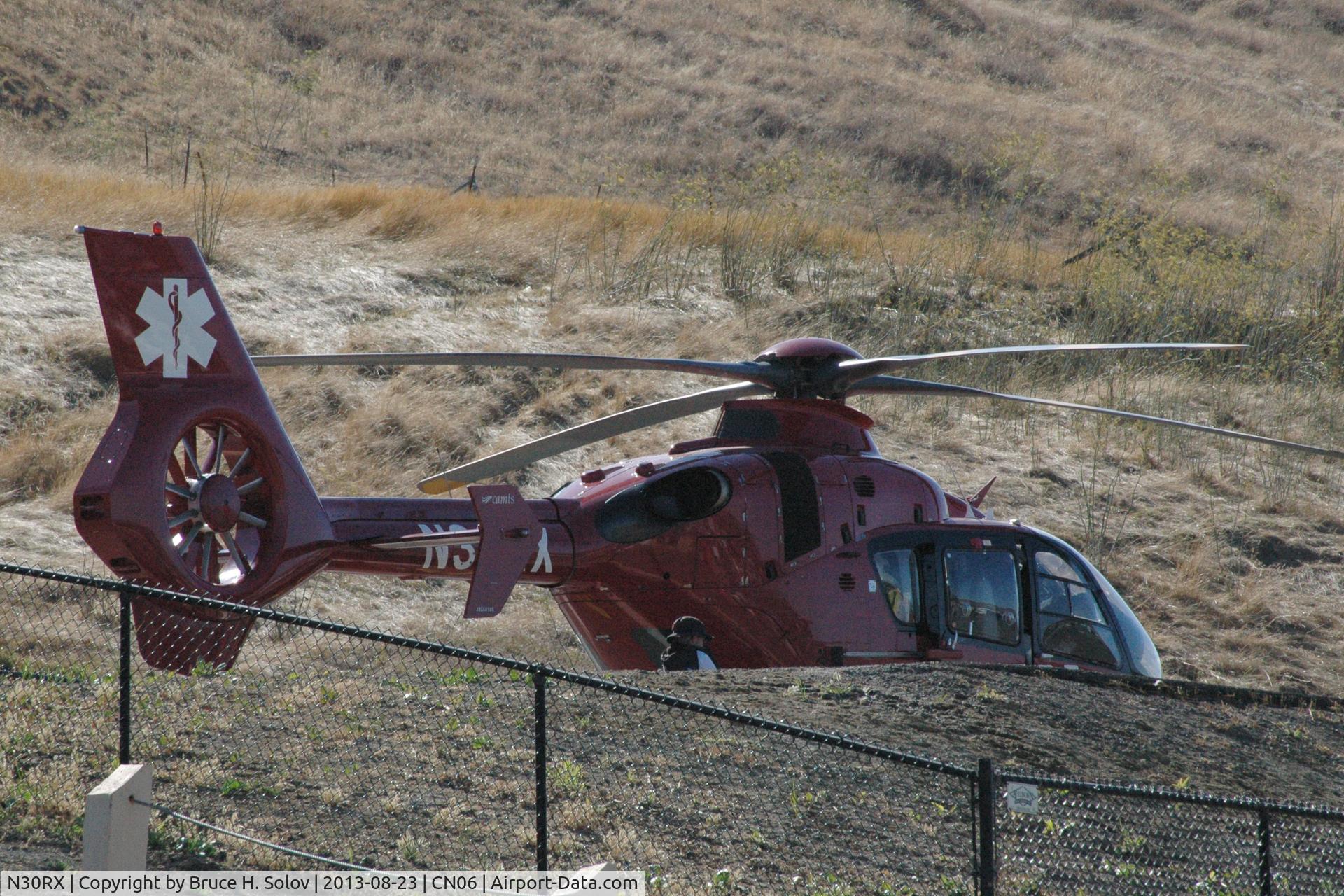 N30RX, 2011 Eurocopter EC-135P-2+ C/N 1001, on the helipad at Sonoma Speedway