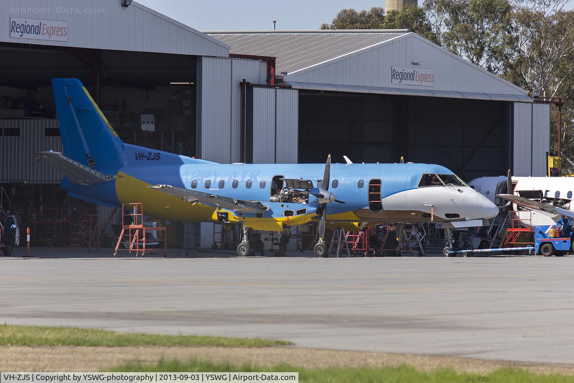VH-ZJS, 1990 Saab 340B C/N 340B-186, Regional Express Saab 340B (VH-ZJS) in former Happy Air Travellers livery at the REX maintenance hangar at Wagga Wagga Airport.