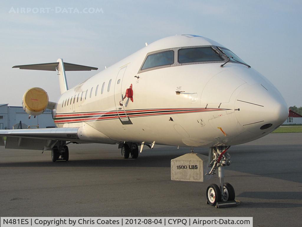 N481ES, 2002 Canadair CL-600-2B19 Regional Jet CRJ-200ER C/N 7717, This nice CRJ sure looked strange this hazy day. It had a 1,500 pound weight hanging under its nose since most of its interior had been removed for refurbishment & the engines are still attached. It's seen here in Peterborough, Ontario. 
