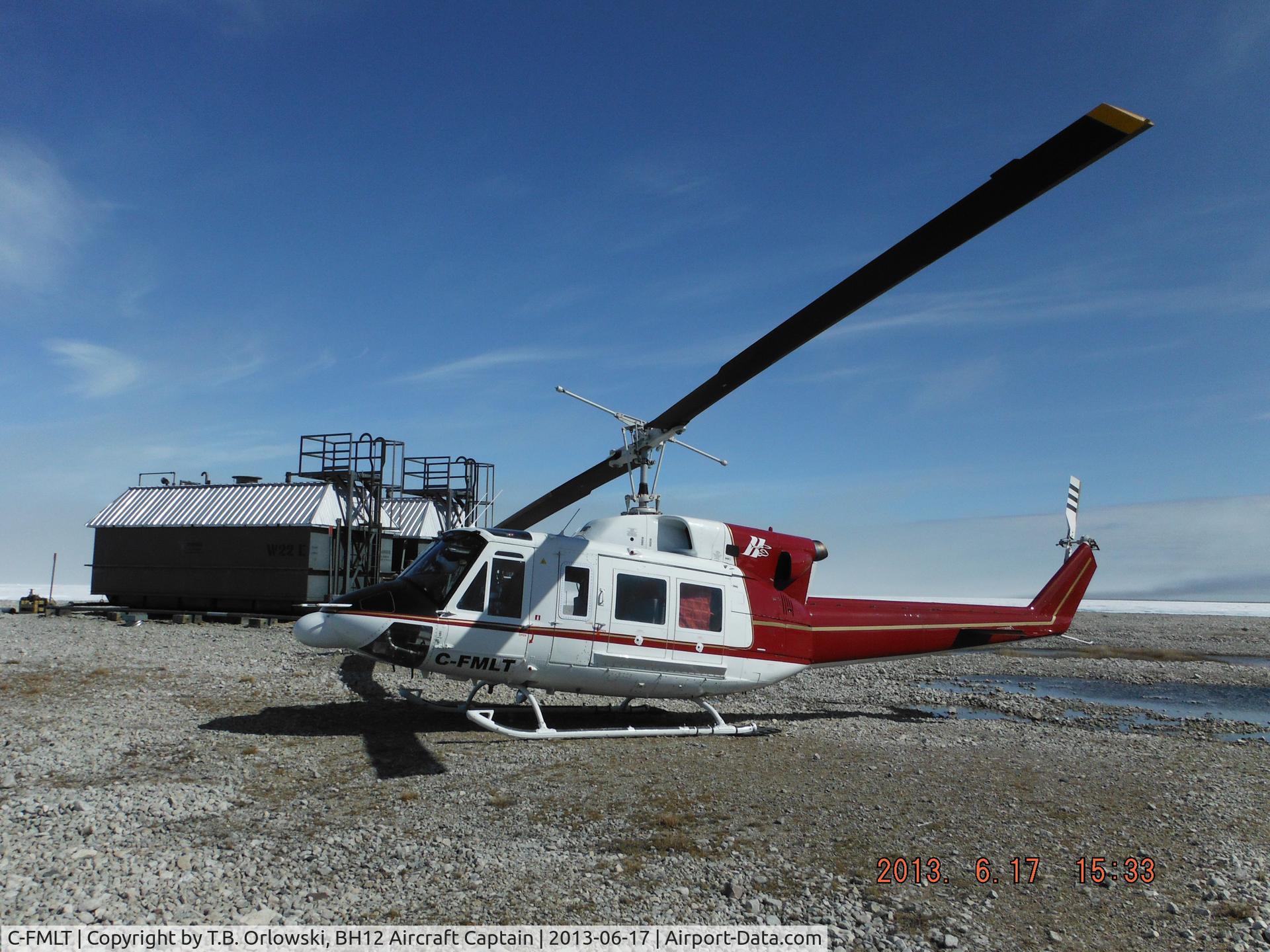 C-FMLT, 1978 Bell 212 C/N 30889, At the beach tanks at Bernard Harbour, Nunavut, Canada (along the North West Passage), with arctic sea ice in the back ground - June 2013. C-FMLT was a former Japanese Coast Guard aircraft and had commenced the contract in white /baby blue paint scheme.