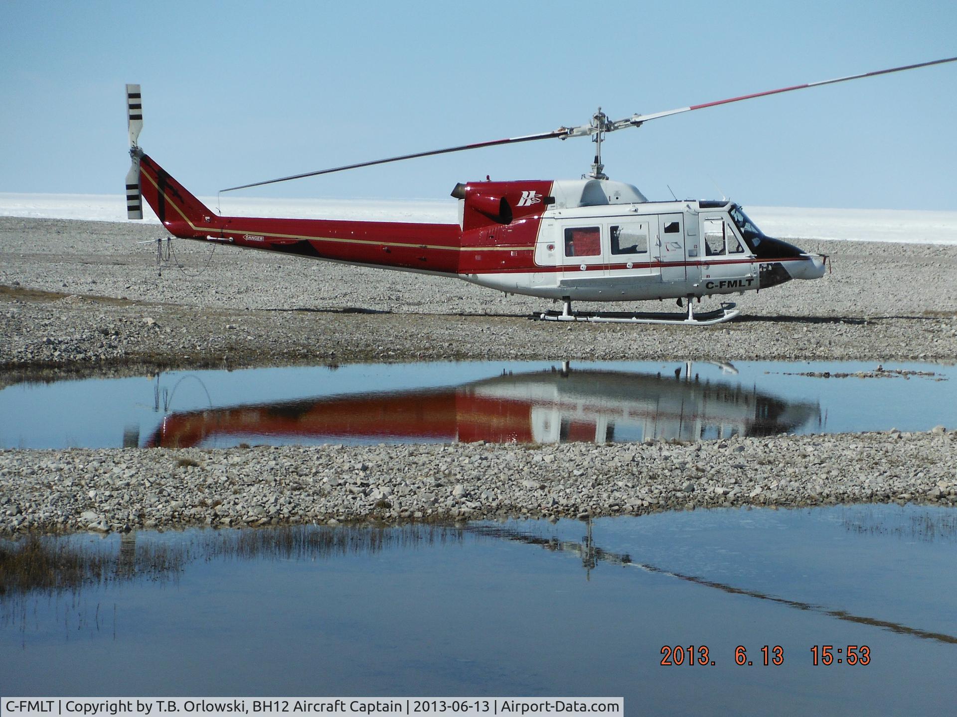 C-FMLT, 1978 Bell 212 C/N 30889, Harding River, Nunavut, Canada (North West Passage) near the beach tanks.  C-FMLT is based in Cambridge Bay (CYCB): it is one of the HTSC helicopters currently contracted for flight operations in support of the North Warning System (NWS).