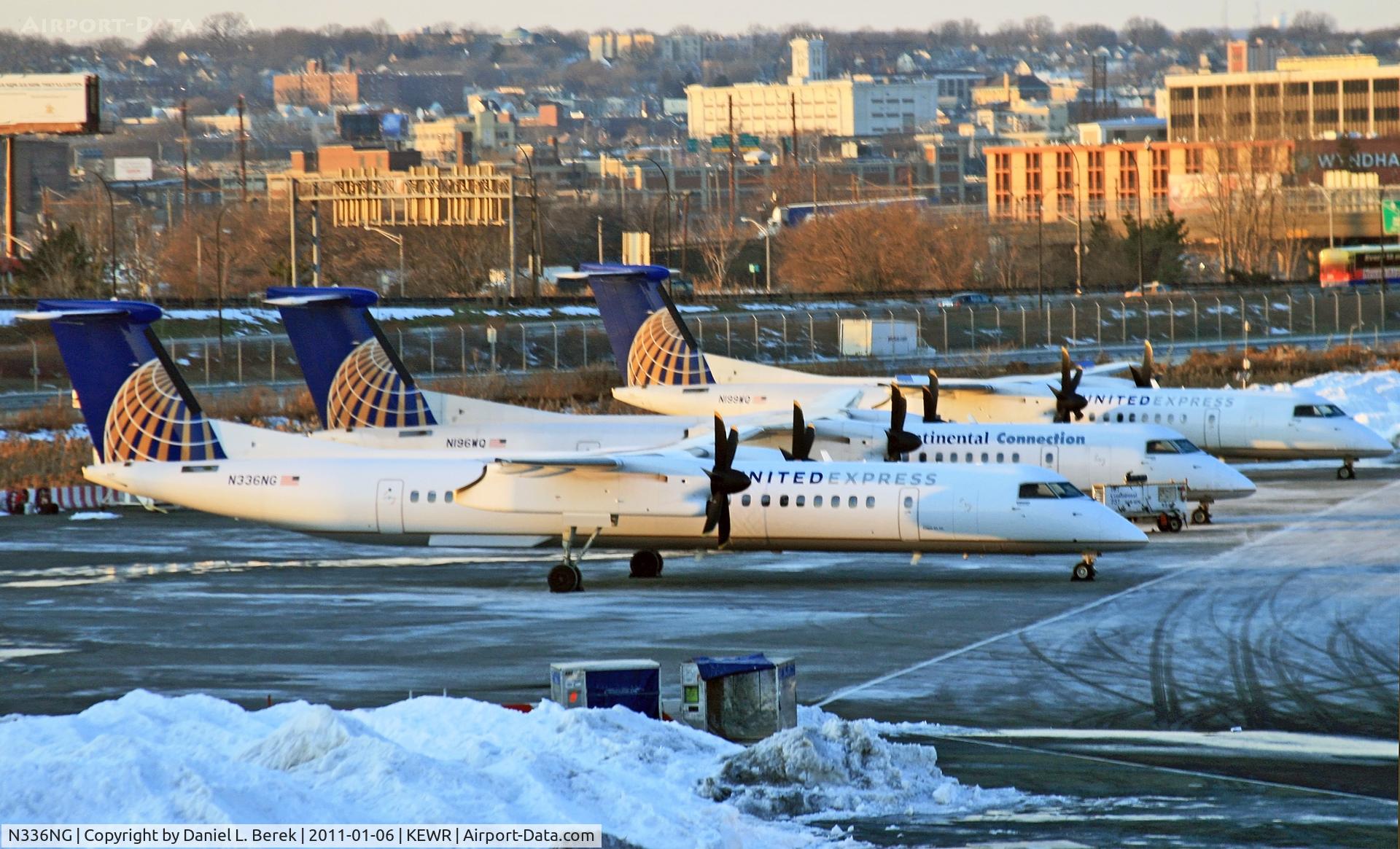 N336NG, 2010 Bombardier DHC-8-402 Dash 8 C/N 4336, A United Express DHC Dash-8 heads up a gaggle of shivering turboprops at a remote corner of EWR on a cold January evening.