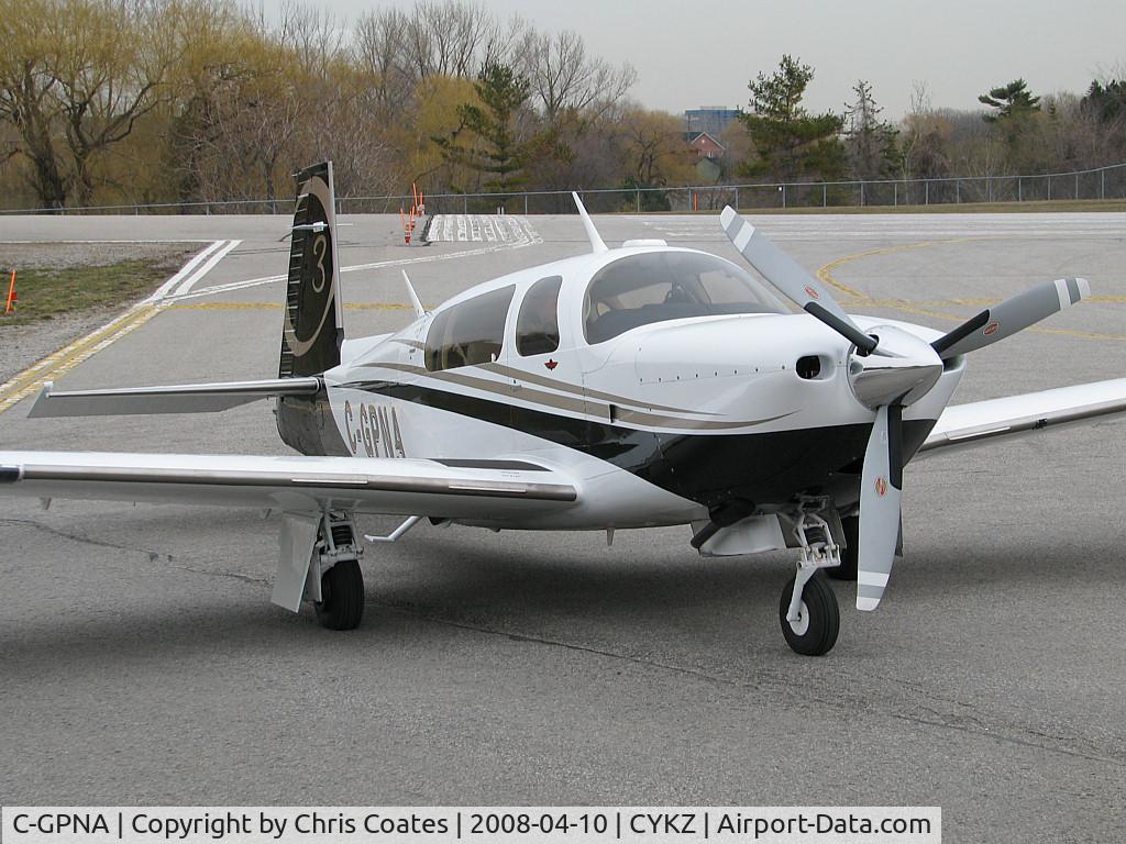C-GPNA, 2007 Mooney M20R Ovation C/N 29-0487, This gorgeous Mooney Ovation was parked at the Terminal on a very dull day. It was always a pleasure to see regardless of the weather. Runway 21's threshold is behind it.