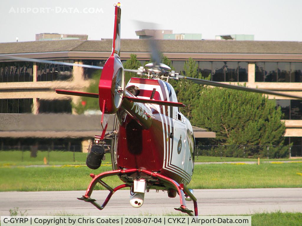 C-GYRP, 2000 Eurocopter EC-120B Colibri C/N 1086, As this Police chopper was cleared for takeoff & was flying away towards the runway the crew still followed me with their high powered camera lens. It was neat to see the white camera working.