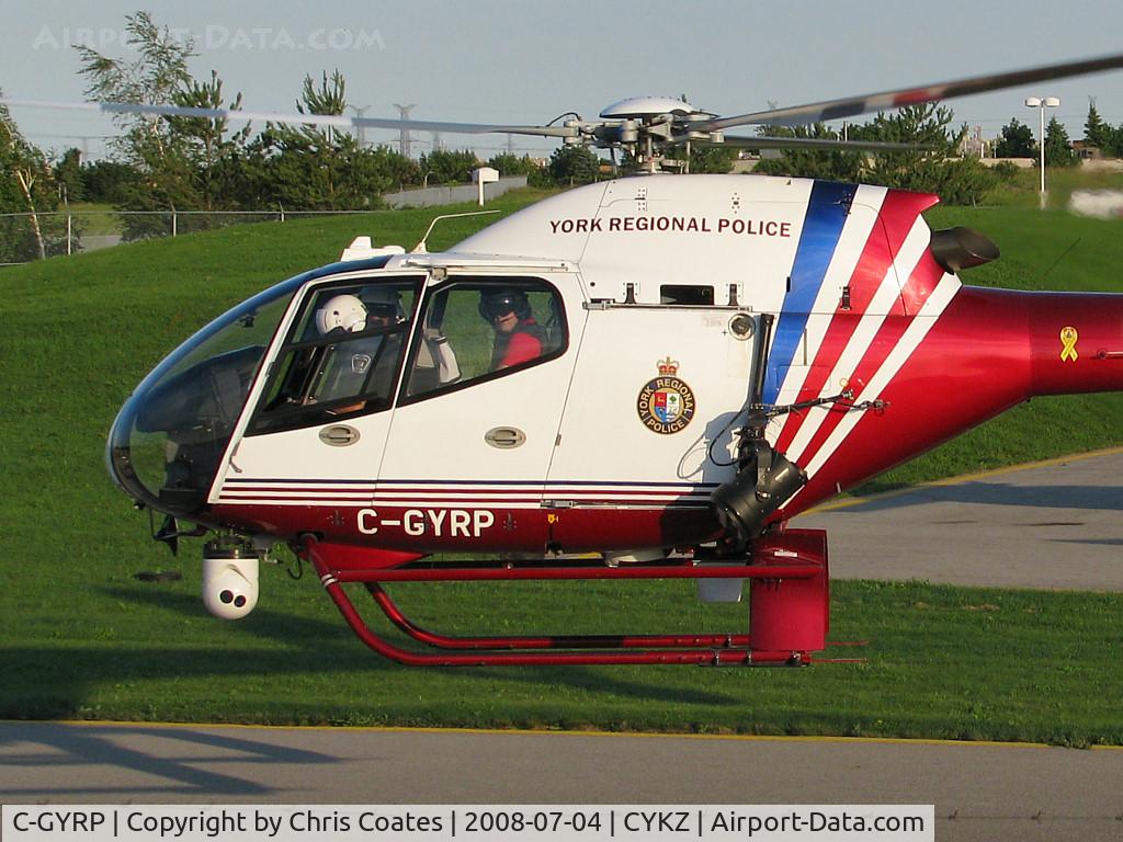 C-GYRP, 2000 Eurocopter EC-120B Colibri C/N 1086, As this Police chopper hover taxied towards the runway the guy in the front left seat kept their white nose mounted camera aimed at me. So I smiled!