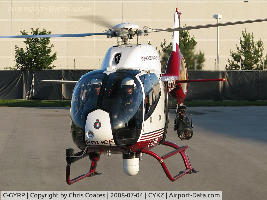 C-GYRP, 2000 Eurocopter EC-120B Colibri C/N 1086, The cops were watching me with interest as they started to taxi out to the active runway. Soon they pointed their camera lens at me. HeHeHe