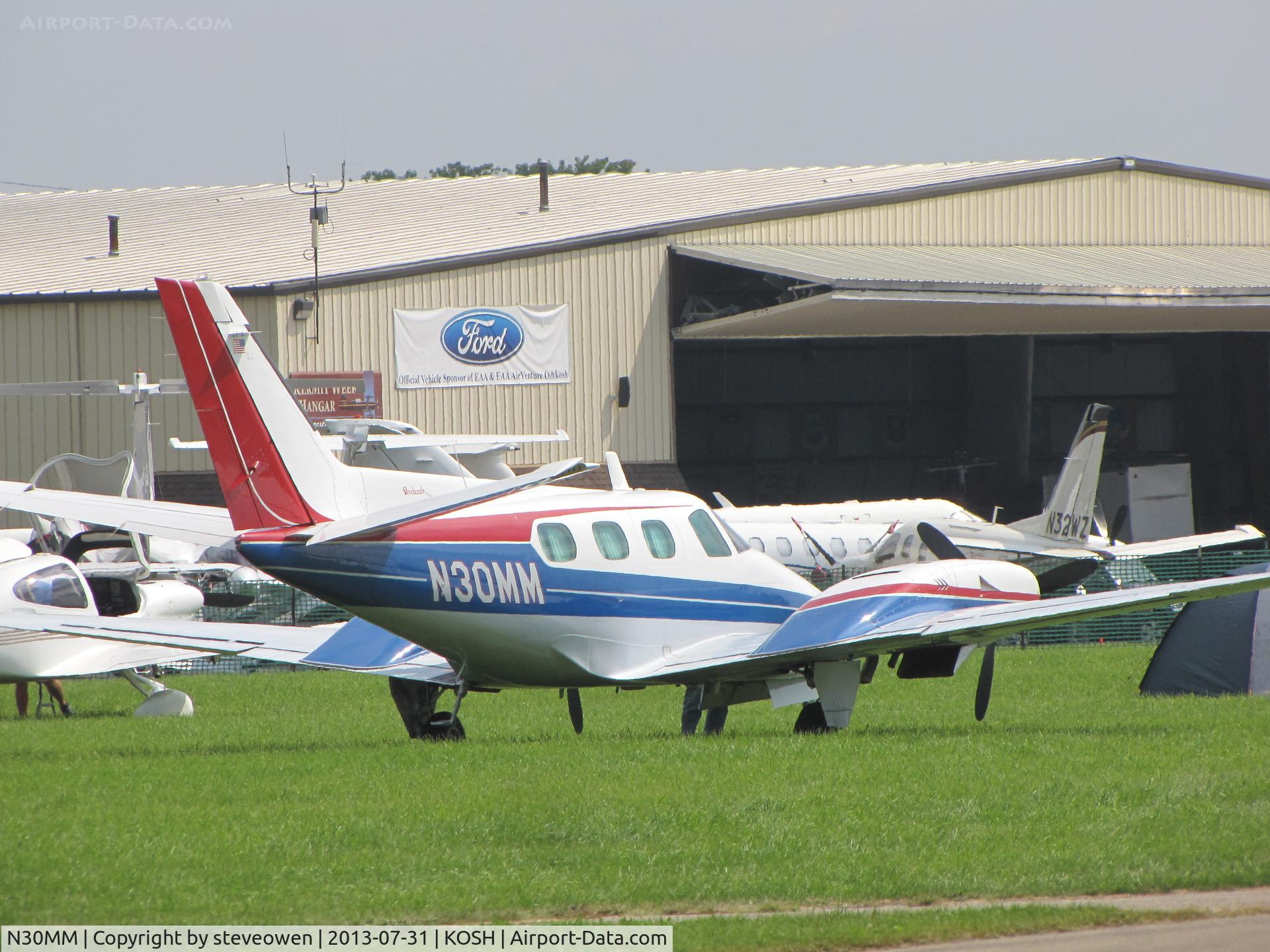 N30MM, 1979 Beech B-60 Duke C/N P-507, parked in the grass at Oshkosh