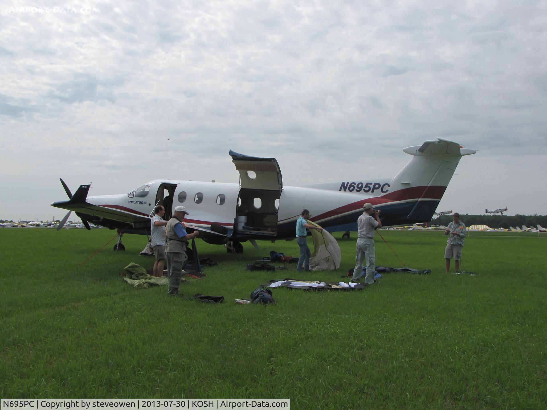 N695PC, 1999 Pilatus PC-12/45 C/N 305, Setting up camp at AirVenture13