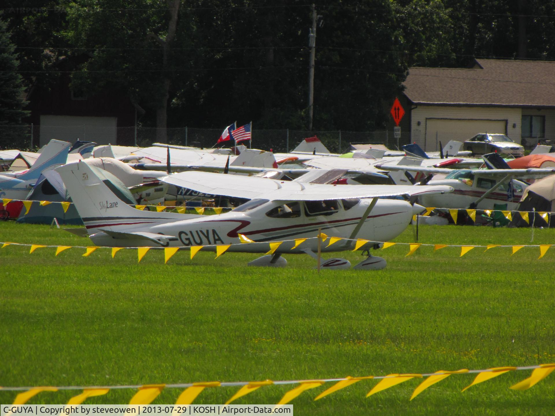 C-GUYA, 2002 Cessna 182T Skylane C/N 18281081, Taxing in the grass at KOSH