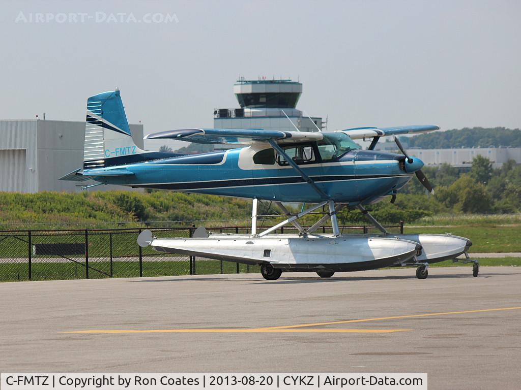 C-FMTZ, 1957 Cessna 180A C/N 32916, 1957 Cessna 180A in its blue paint job with the Buttonville Control Tower in the background
