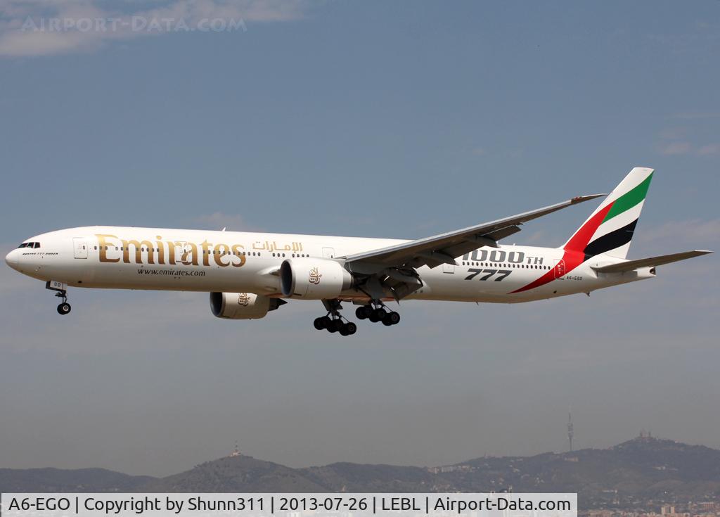 A6-EGO, 2012 Boeing 777-31H/ER C/N 35598, Landing rwy 25R with additional '1000th 777' titles for the 1000th B777 built
