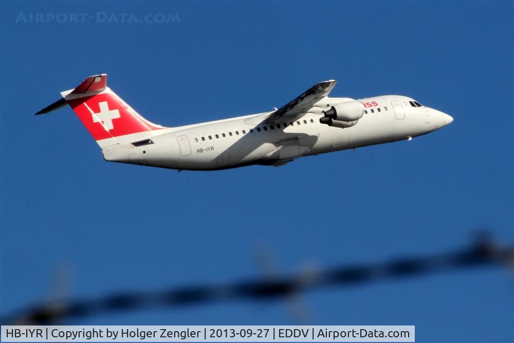 HB-IYR, 2001 British Aerospace Avro 146-RJ100 C/N E3382, Snapshot thru barb wire....