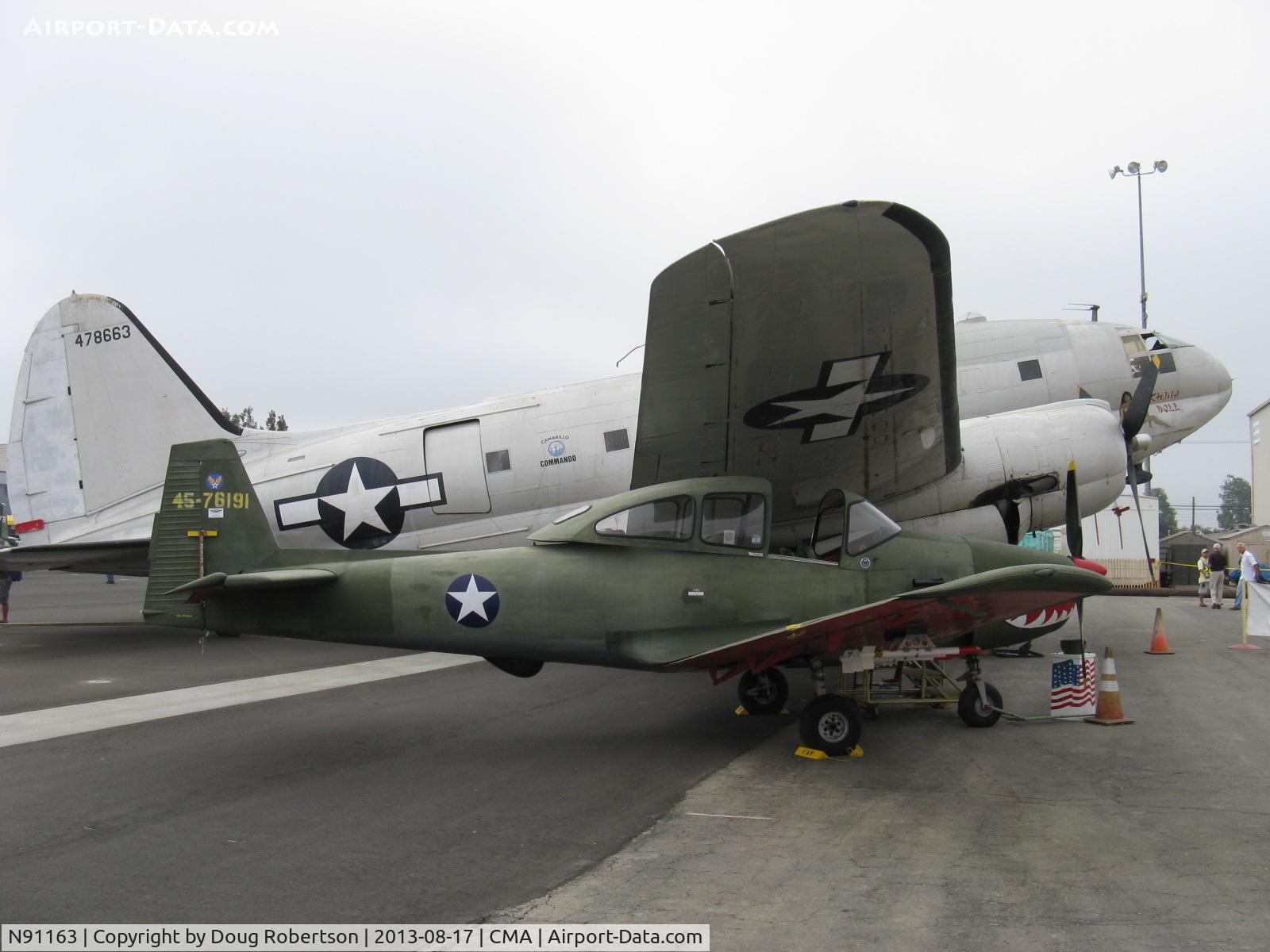 N91163, 1946 North American Navion C/N NAV-4-217, 1946 North American NAVION, Continental E-225, finished/stenciled as a UC-17 warbird, but never was a UC-17, on CAF ramp under wing of their C46 'China Doll'