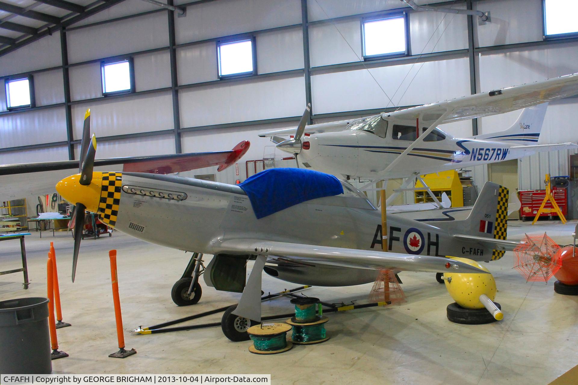 C-FAFH, 1999 Mustang F.E.W. TP-51 C/N 0051, Tucked into a hangar at Muskoka airport, Ontario