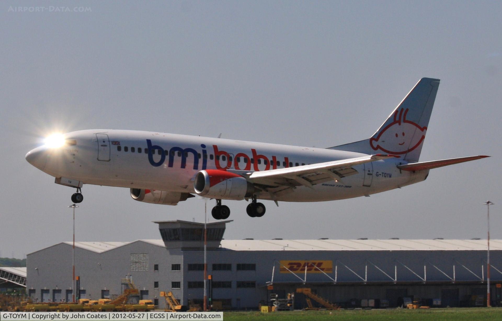 G-TOYM, 1998 Boeing 737-36Q C/N 29141, Catching the sun before touchdown.