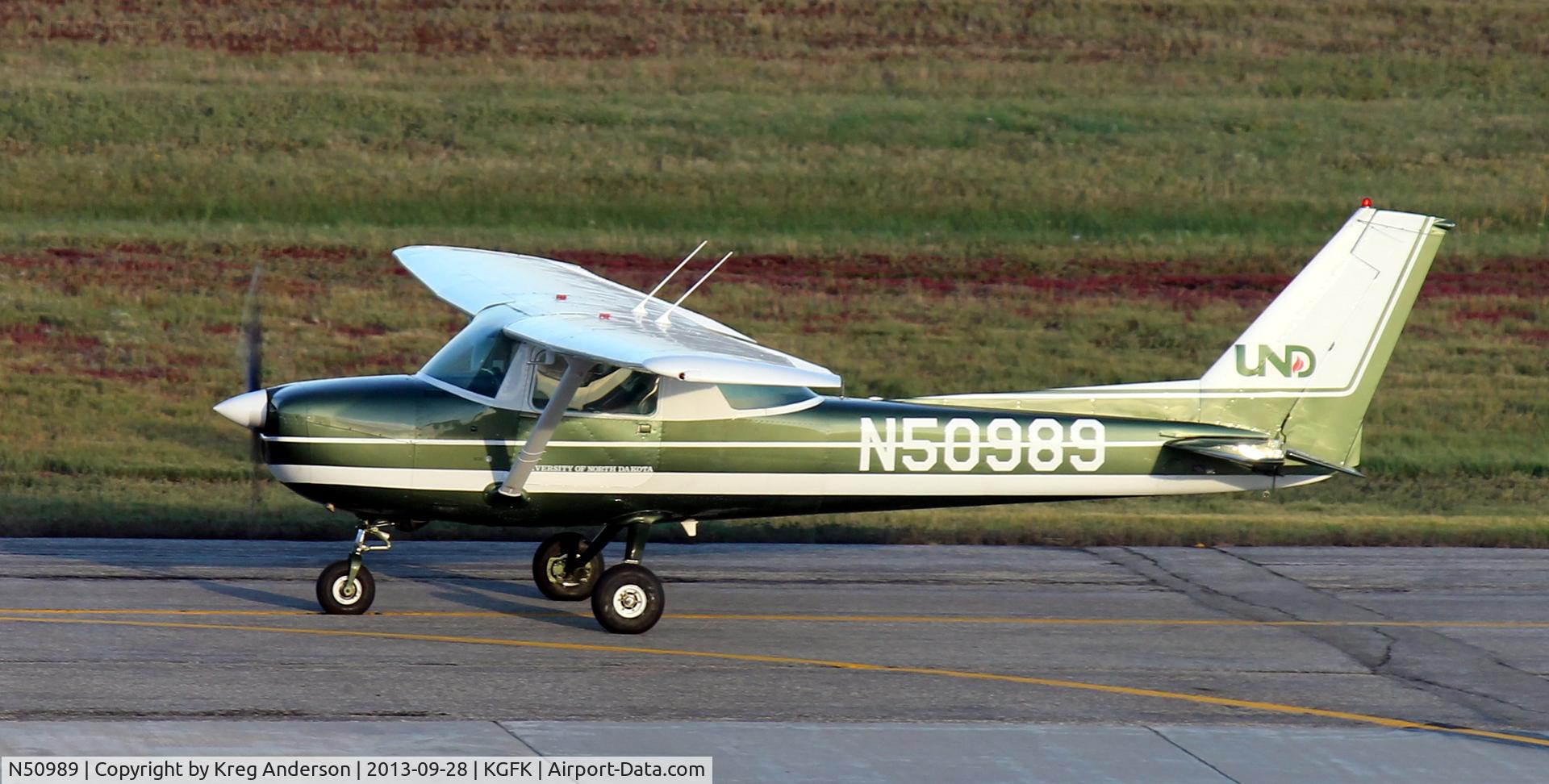 N50989, 1975 Cessna 150M C/N 15077226, University of North Dakota Cessna 150M taxiing from the Charlie ramp to the active runway.