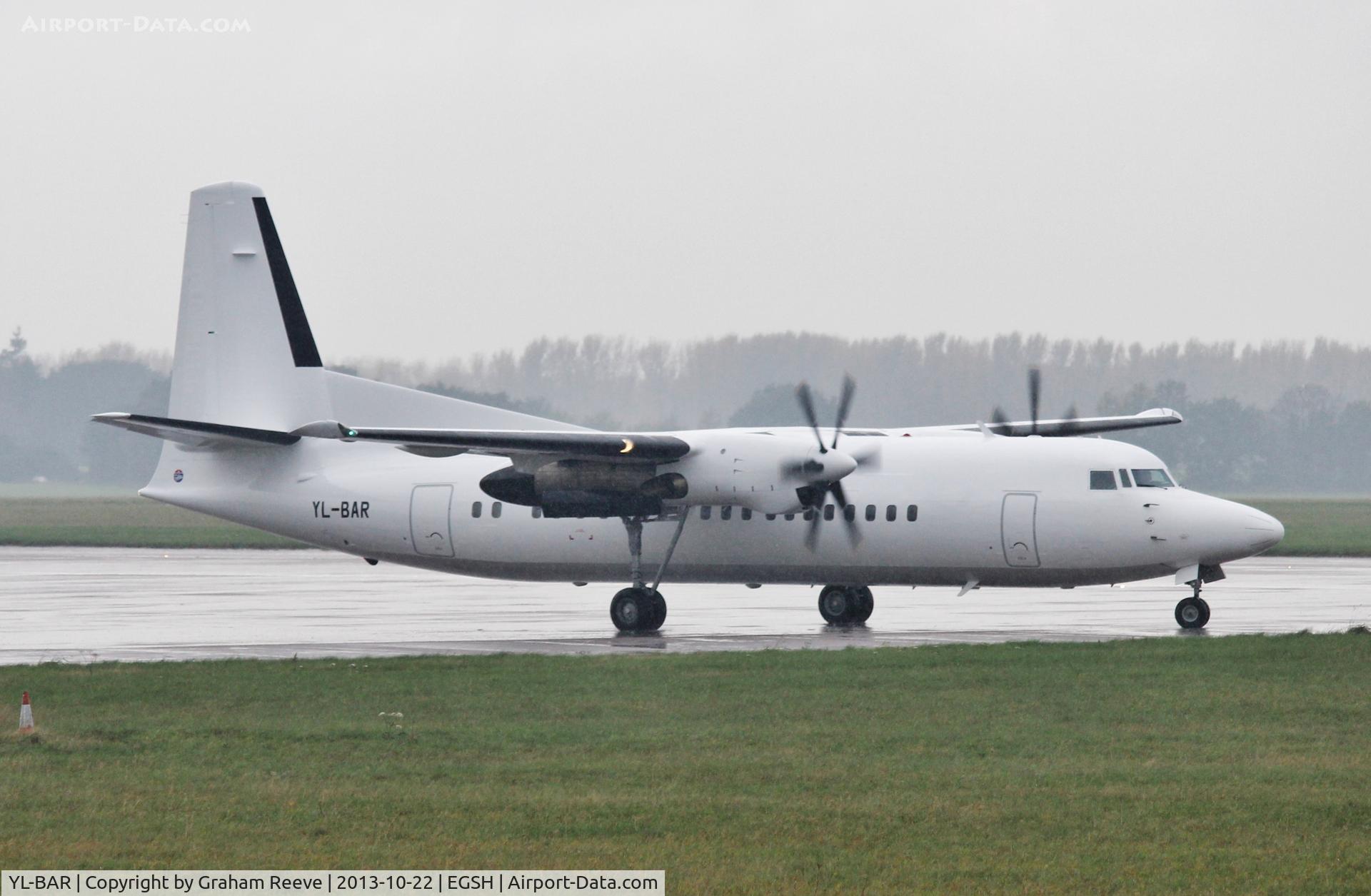 YL-BAR, 1989 Fokker 50 C/N 20149, About to depart during a heavy rain storm.