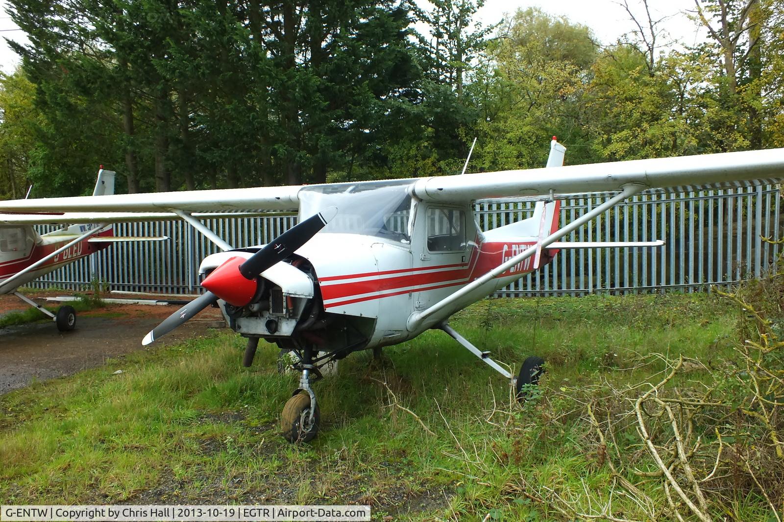 G-ENTW, 1978 Reims F152 C/N 1479, parked in the gap between two hangars
