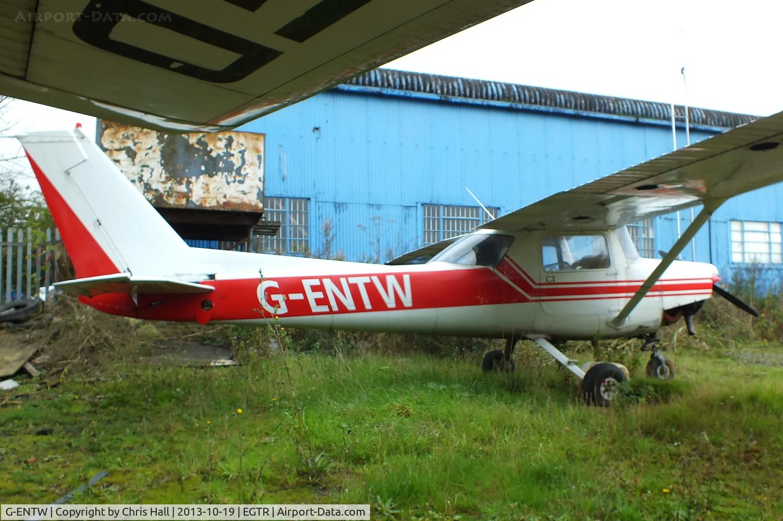 G-ENTW, 1978 Reims F152 C/N 1479, parked in the gap between two hangars