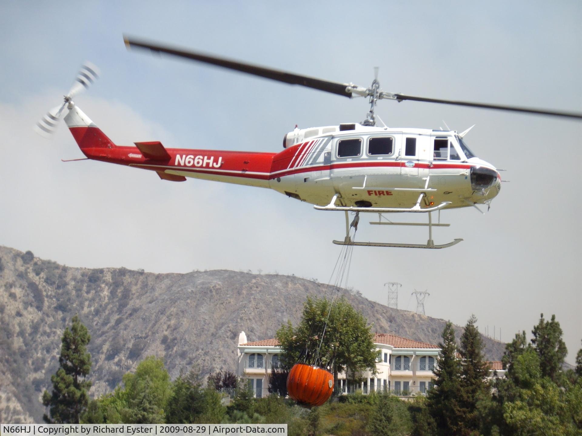 N66HJ, 1976 Bell 205A-1 C/N 30239, Taken during the Station fire in 2009.  N66HJ had just filled it's bucket from a water hazard at the Flintridge Country Club Golf Course.
